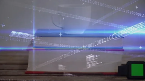 Faint binary streams appearing causing scanning of books mug watch by light Stock Footage 311083448