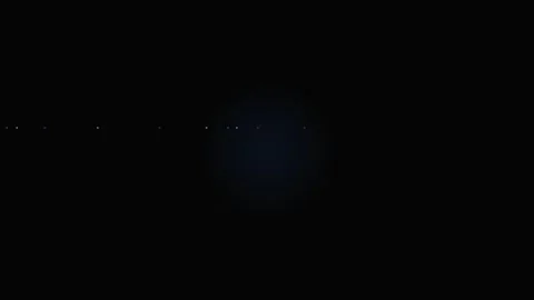 A faint blue light glowing in the center of a pitch black dark background Stock Footage 339617365
