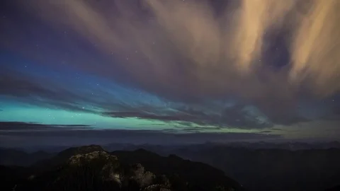 Faint Northern Lights Behind Slow Clouds Above Mountains Stock Footage 73240877