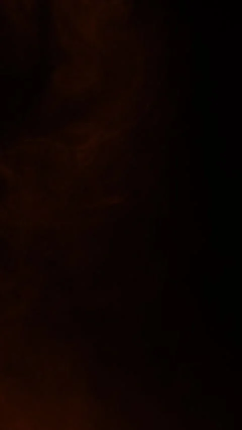 Faint orange ember fog floating on black background, vertical format Stock Footage 340131486