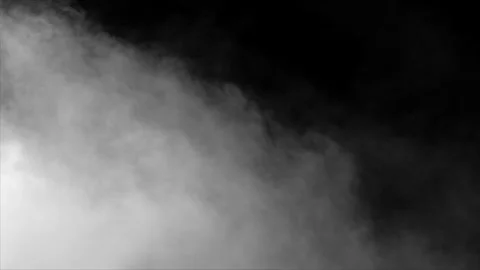 Faint puff of smoke enters frame on black background Stock Footage 312664327