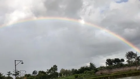 A Faint Rainbow in a Cloudy Sky Stock Footage 330166282