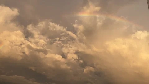 Faint Rainbow Over Dramatic Cumulus Clouds At Evening Sunset 库存影片 296002718