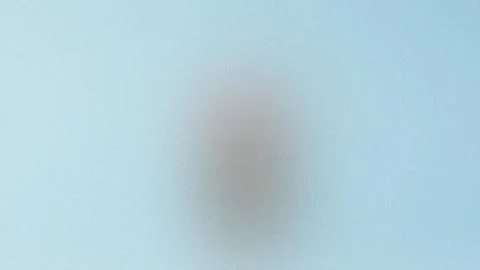 Faintly Visible Oval Shape on a Light Blue Background blurred object Stock Illustration
