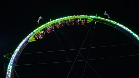 Fair circle roller coaster carnival at night neon glow Stock Footage 115864537