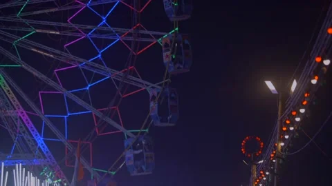 Fair ferris wheel lights decorated in mela festival Stock Footage 220765640
