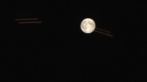 Fair ground ride passes over moon at night.  Static MS. Stock Footage 27551727
