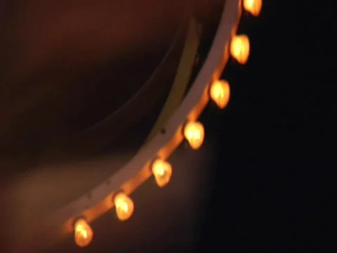 FAIR RIDE GLOBE SPINS BRIGHT LIGHTS NIGHT CLOSE Stock Footage