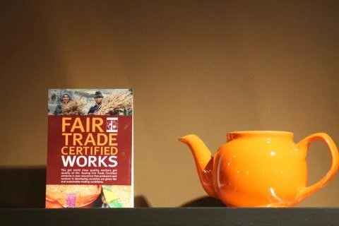 Fair trade sign and teapot Stock Photos