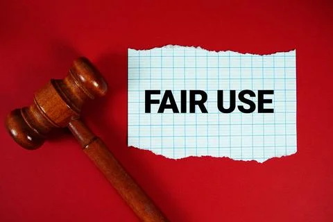 Fair Use text written on rip paper with wooden judgment gavel on red backgrou Stock Photos