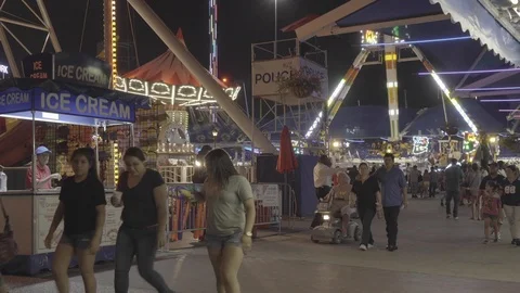 Fair/Carnival Crowds Walking By at Night Stock Footage 100705330