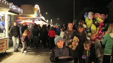 Fairground - crowds walk past camera Stock Footage 10689307