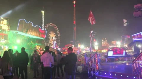 Fairground - crowds walk past camera- lads pull faces at camera towards end Stock Footage 10689397