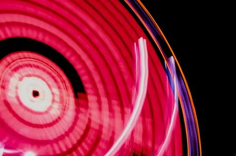 Fairground Ferris wheel illuminated at night with Stock Photos