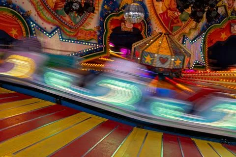 Fairground lights blurring from motion creating vibrant streaks of light an.. Stock Photos