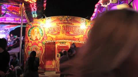 Fairground - magic mirror attraction with crowds passing by Stock Footage 10688825