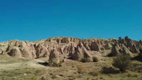 Fairy chimneys side view on a sunny day in Cappadocia, Turkey. Stock Footage 166837208