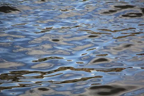 Fairy tale patterns on multicolor waves of water Stock Photos