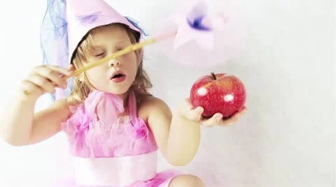Fairy trying to make an apple disappear Video stock 11810924