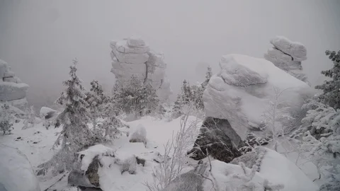 Fairy winter forest after snowfall and icy rocks on the mountain. Stock Footage 129546956