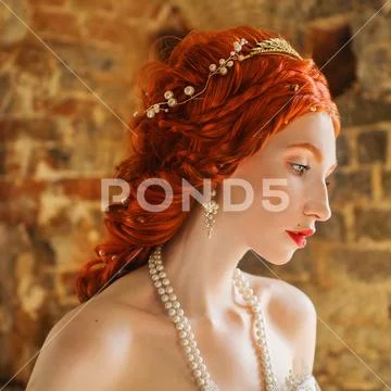 Fairytale hero. Renaissance redhead princess with hairstyle in castle. Fabulo Stock Photos