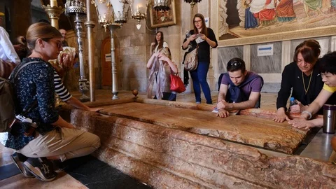 Faithful Pray Over The Stone Of Unction In The Basilica Of The Holy Sepulcher Stock Footage 90577011
