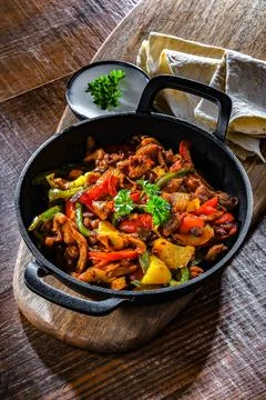 Fajita with stripped peppers and onions served on a hot iron skillet Stock Photos