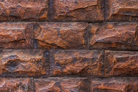 Fake brick wall, plastic panel imitating natural stone blocks wall brickwork Stockfoto's