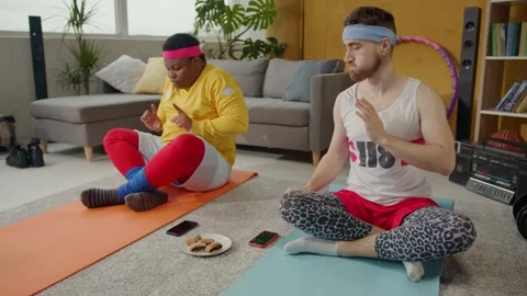 Fake funny sporting guys performing home meditation together. Foolish bearded Stock Footage 133074873