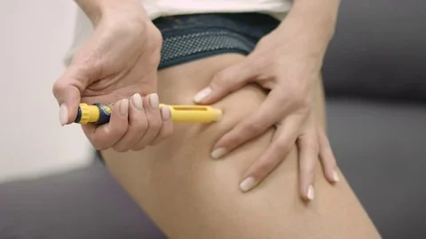 Fake Insulin self injection in hip Stock Footage 70815698