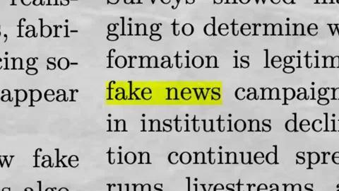Fake News Highlighted in Newspaper Article Misinformation and Media Stock Footage 335343733