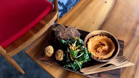 Falafel and hummus spread served with salad on wooden board Stock Footage 278445145