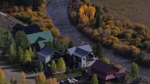 Fall aerial close up homes along East River in Crested Butte South Colorado Stock Footage 346649624