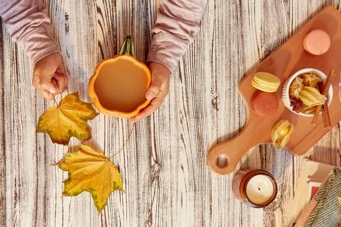 Fall aesthetic composition - child hands holding a cup of cocoa and autumn Stock Photos