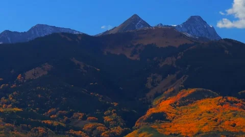 Fall Autumn sunny blue sky morning Aspen Capitol Peak Mount Snowmass aerial Video stock 314245378