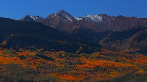 Fall Autumn sunny blue sky morning Aspen Capitol Peak Mount Snowmass aerial Video stock 314245390