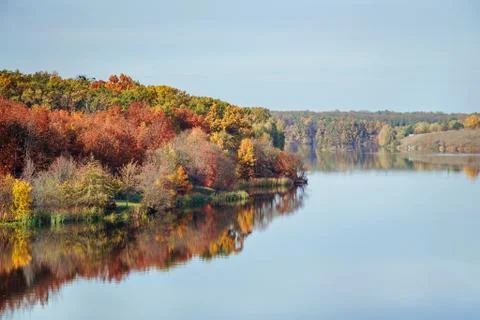 Fall autumn view on the multi colored autumn forest reflecting in the water Stock Photos