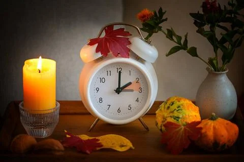 Fall back, time change on a white alarm clock after daylight saving time, ... Stock Photos