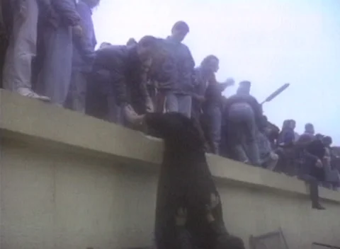 Fall of the Berlin Wall 1989 | Jubilent Crowd Scaling the Top | Chiseling Pieces 库存影片 225841741