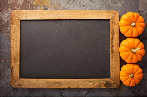 Fall chalkboard frame with pumpkins Stock Photos