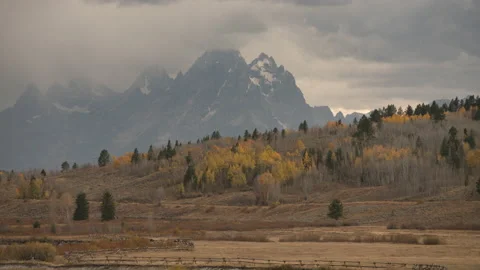 Fall Color and Storm rolling in through the Grand Teton Range Stockbeeldmateriaal 142419077