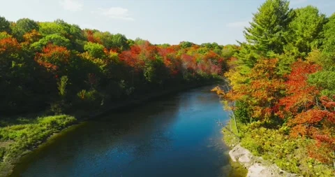 Fall color mid height around bend of river Stock Footage 256915209