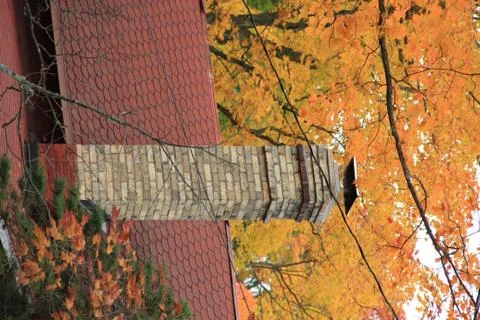 Fall colors behind a brick chimney Stock Photos