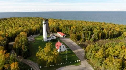 Fall colors Woods or Forest w Lake Lighthouse Aerial Flyover Orbit   2 스톡 동영상 68771234