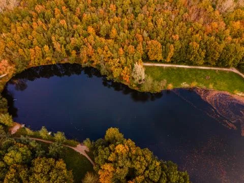 Fall colour reflected in the still waters of a lake near Urk Netherlands Stock Photos