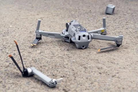 The fall of the drone. a broken flying quadcopter is lying on the asphalt, the Stock-Fotos
