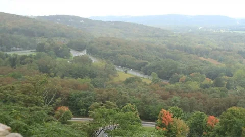 Fall freeway traffic among trees Video stock 8778094