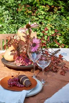 Fall garden table setting with pumpkins and hydrangea in brown and burgundy tone 스톡 사진