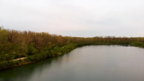 Fall Lake with City Reveal - 4K Aerial Stock Footage