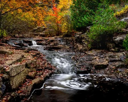 Fall landscape long exposure of view of waterfalls along the Duck Brook Stock Photos